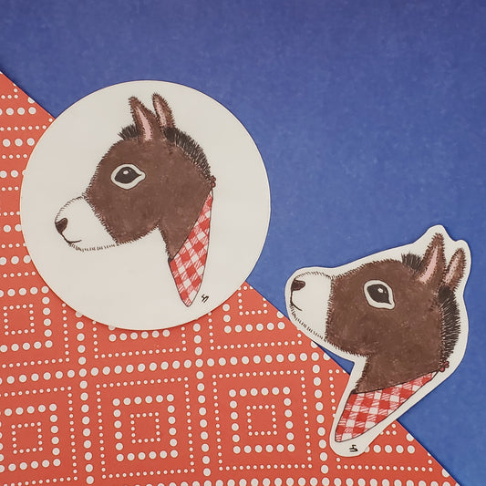 Two donkey stickers on a blue and red patterned background
